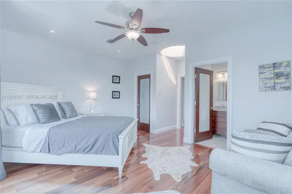 a living room with furniture and wall paintings