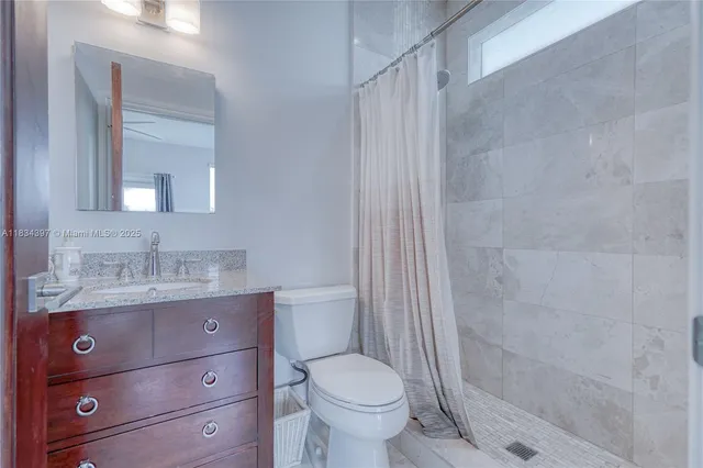 a spacious bathroom with a double vanity sink a large mirror a bathtub and window