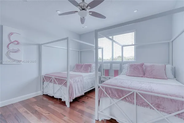 a spacious bathroom with a double vanity sink a large mirror a bathtub and window