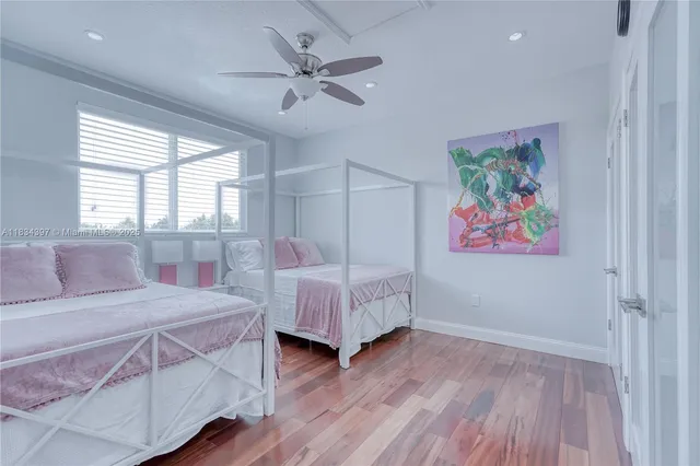 a white bath tub sitting in a bathroom next to a window