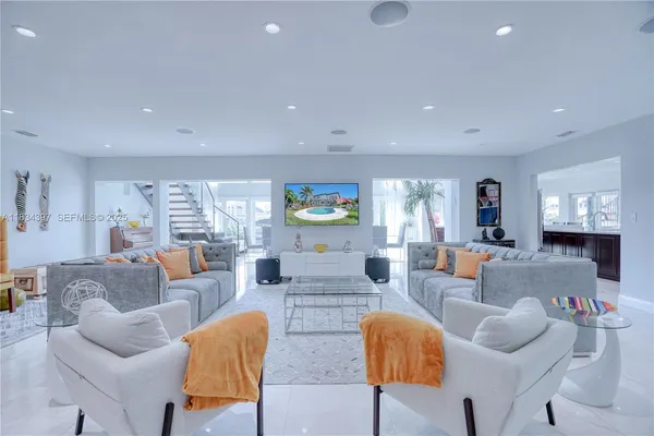 a kitchen with stainless steel appliances kitchen island granite countertop a stove a sink a refrigerator and a refrigerator