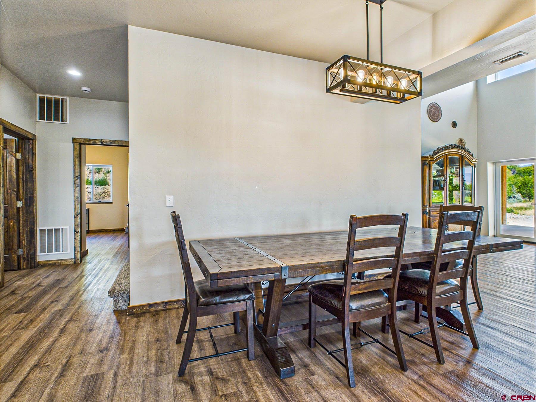 14885 G Road Delta, CO 81416 - Photo 15 of 45 a view of a dining room with furniture a chandelier and wooden floor