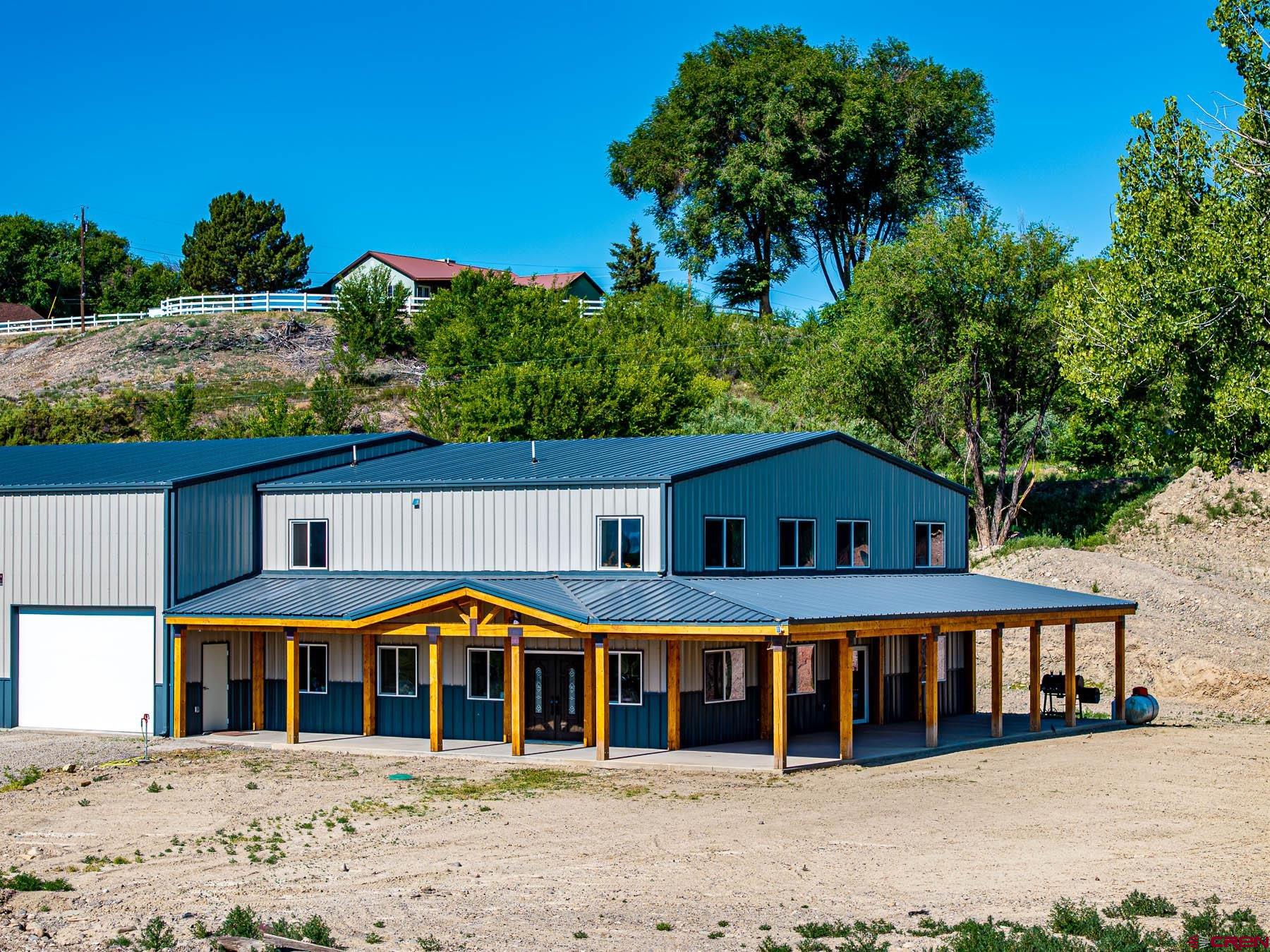 14885 G Road Delta, CO 81416 - Photo 2 of 45 a front view of a house with a garden