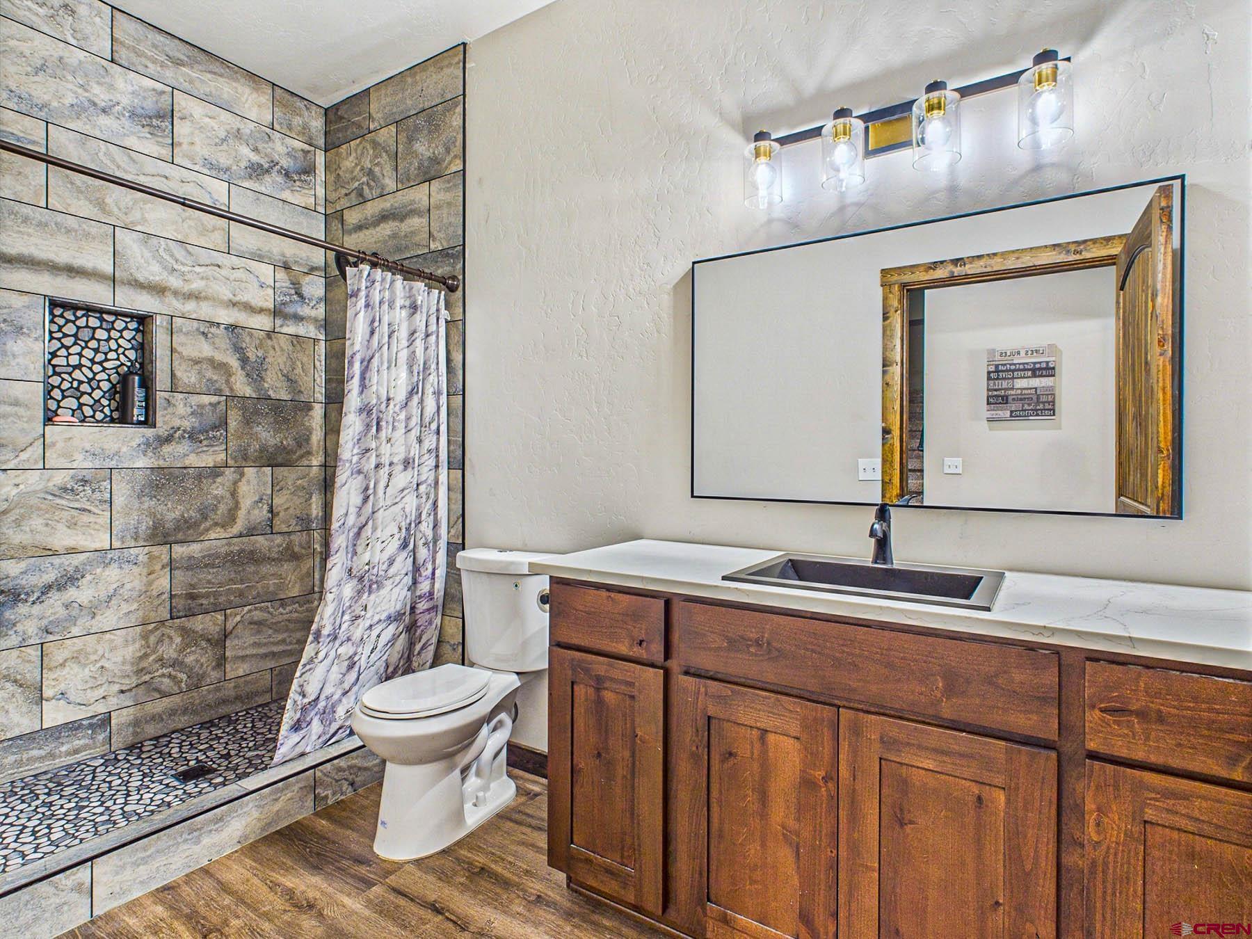 14885 G Road Delta, CO 81416 - Photo 22 of 45 a bathroom with a sink toilet and shower