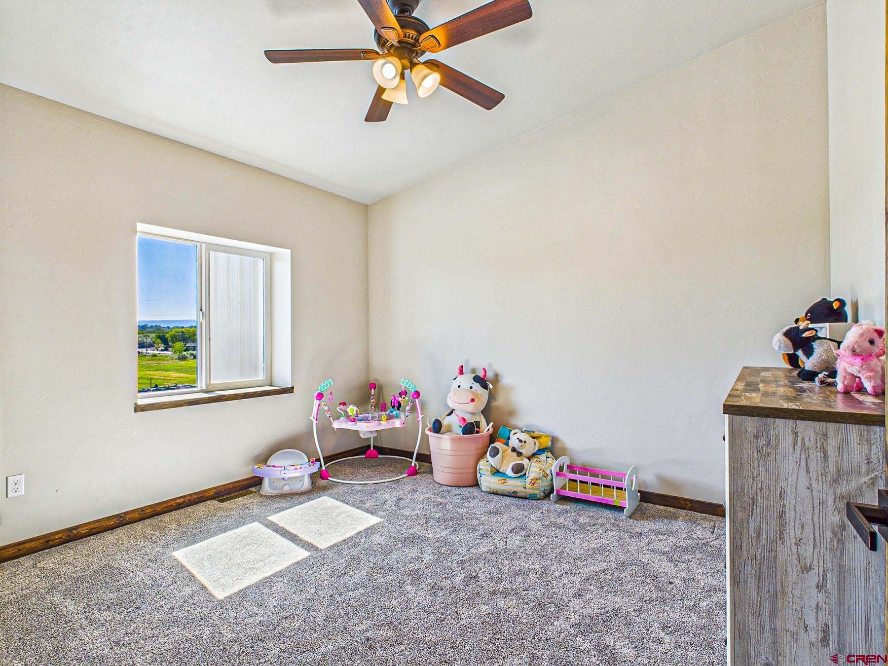 14885 G Road Delta, CO 81416 - Photo 28 of 45 a view of a room with toys and ceiling fan