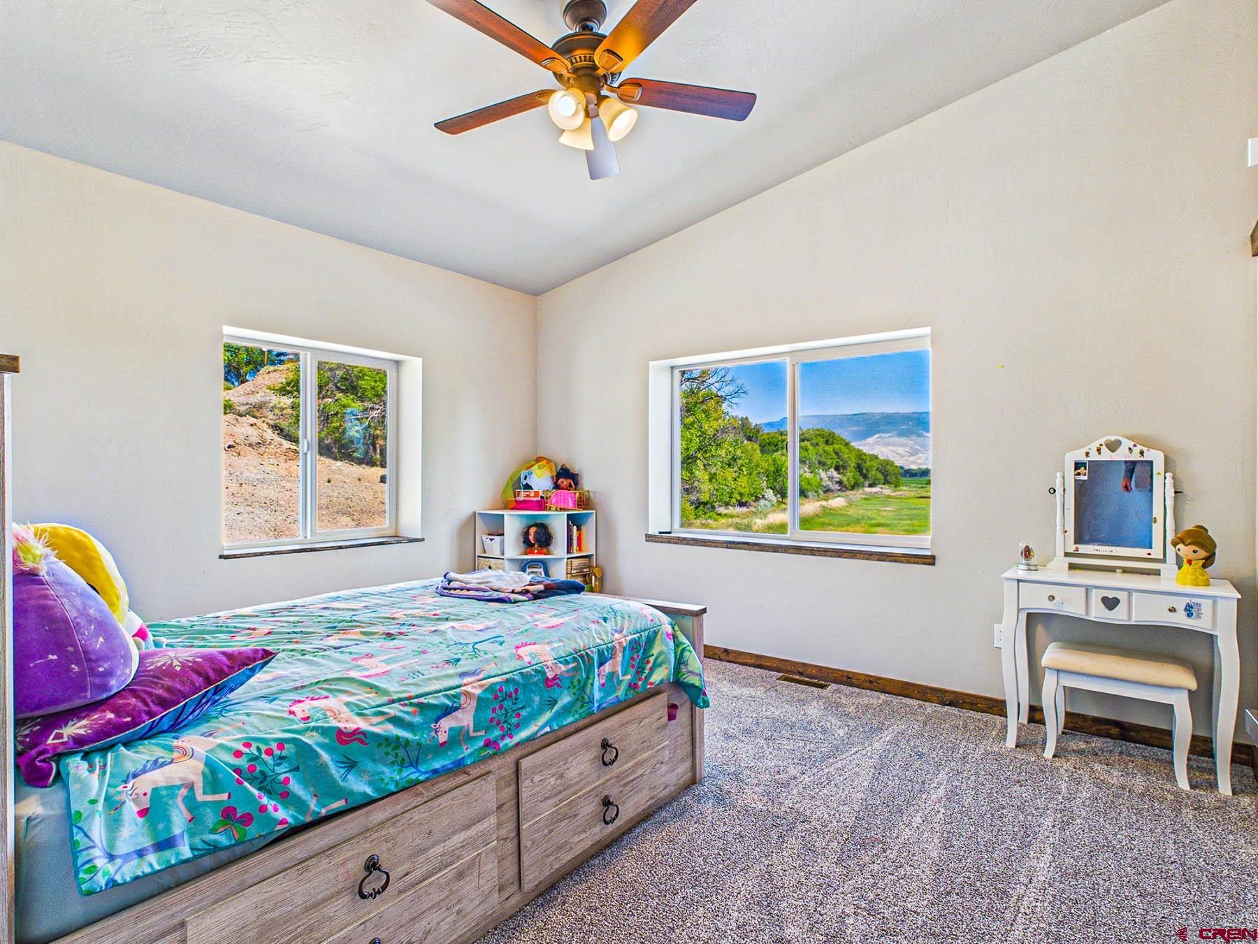 14885 G Road Delta, CO 81416 - Photo 31 of 45 a bedroom with furniture and a window