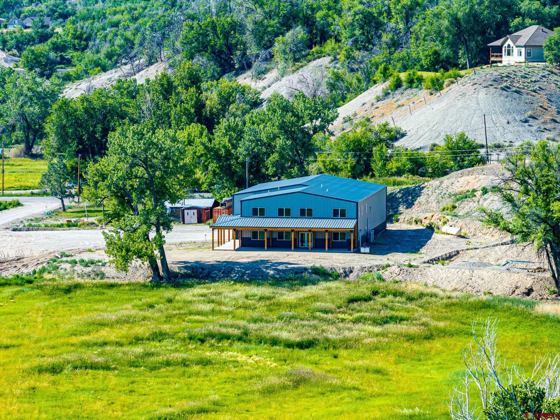 14885 G Road Delta, CO 81416 - Photo 40 of 45 a view of a house with pool and sitting area