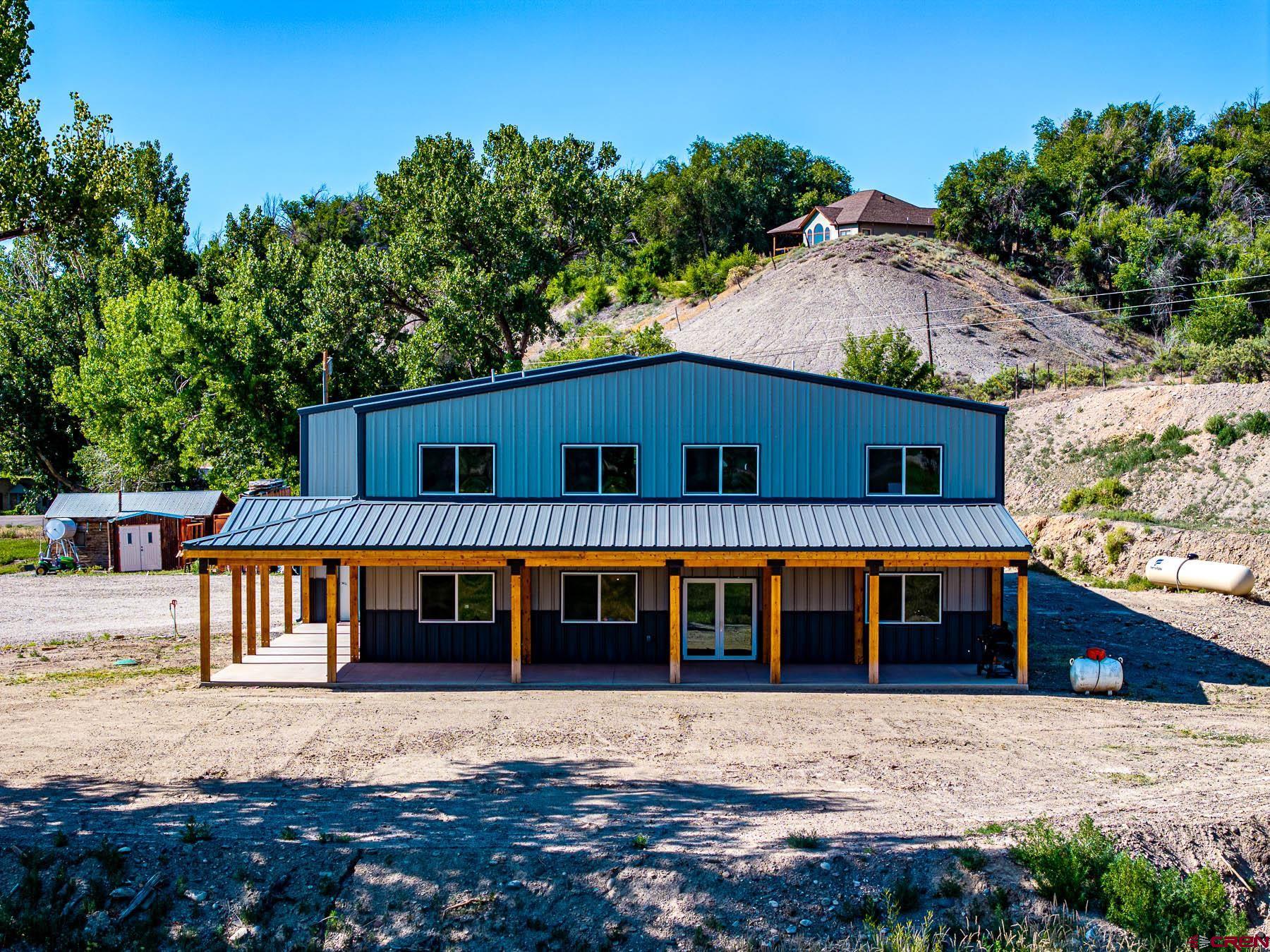 14885 G Road Delta, CO 81416 - Photo 6 of 45 a front view of a house with yard and seating space