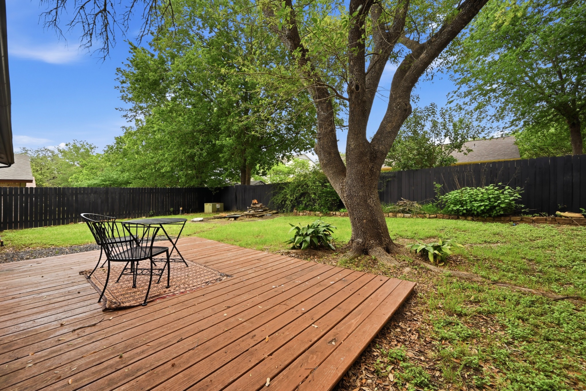 6805 Rearden Road Austin, TX 78745 - Photo 22 of 26 A spacious yard with mature trees offers a private deck perfect for outdoor enjoyment.
