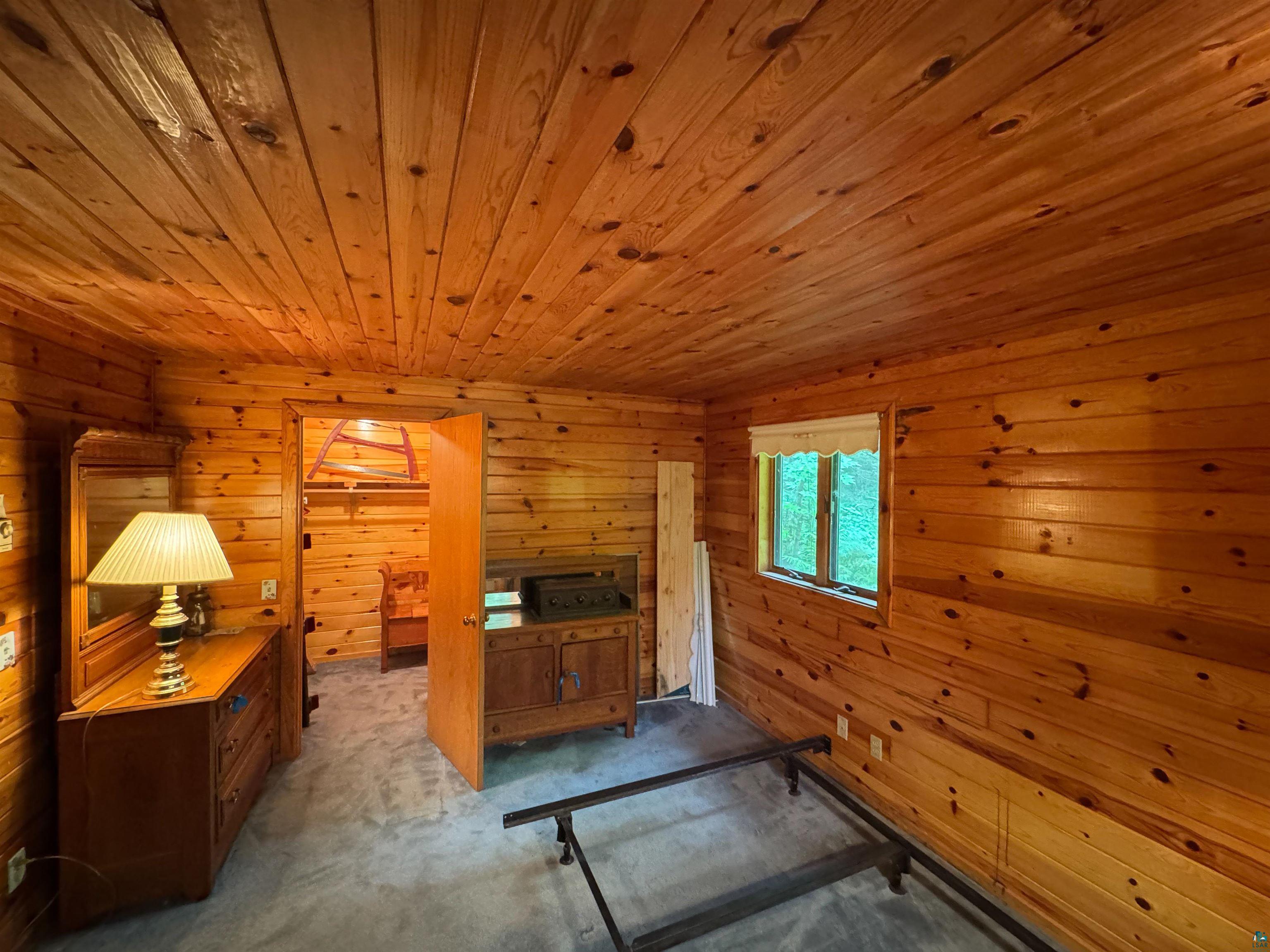 465 South Gunflint Lake Road Grand Marais, MN 55604 - Photo 34 of 46 Paneled wood walls and ceiling with a double window