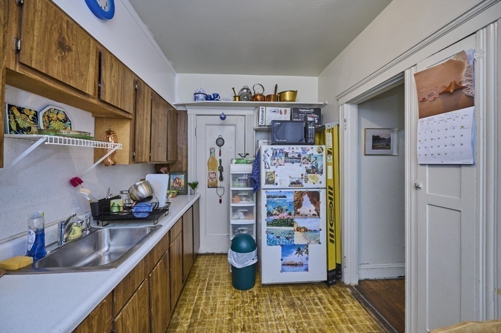 15 Colliston Road, Unit 6 Boston, MA 02135 - Photo 11 of 17 a kitchen with a refrigerator and a stove top oven