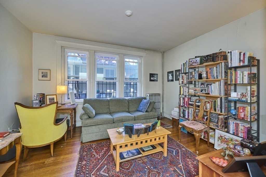 15 Colliston Road, Unit 6 Boston, MA 02135 - Photo 2 of 17 a living room with furniture and a book shelf