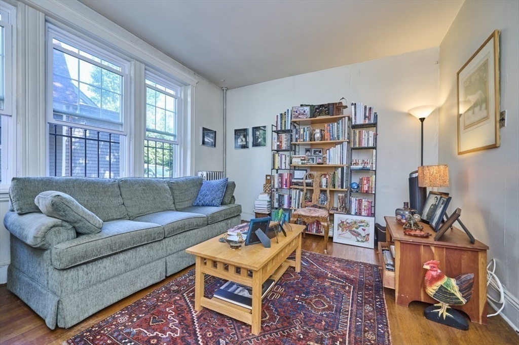 15 Colliston Road, Unit 6 Boston, MA 02135 - Photo 3 of 17 a living room with furniture a bookshelf and a window