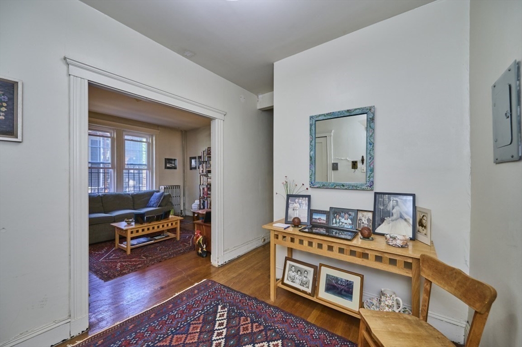15 Colliston Road, Unit 6 Boston, MA 02135 - Photo 5 of 17 a living room with furniture and a wooden floor