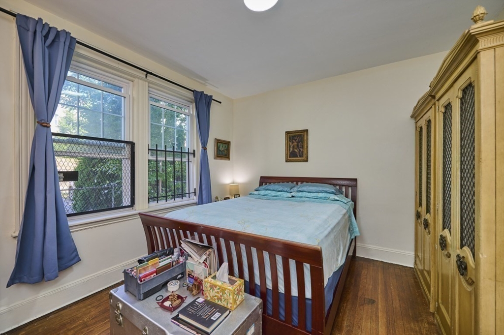 15 Colliston Road, Unit 6 Boston, MA 02135 - Photo 6 of 17 a bedroom with a bed and wooden floor