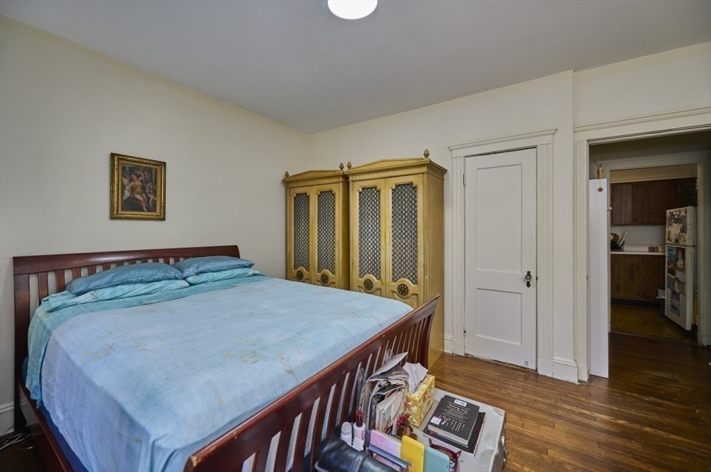 15 Colliston Road, Unit 6 Boston, MA 02135 - Photo 7 of 17 a bedroom with a bed and wooden floor