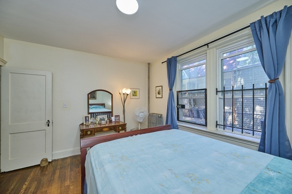 15 Colliston Road, Unit 6 Boston, MA 02135 - Photo 8 of 17 a bedroom with a bed and a large window