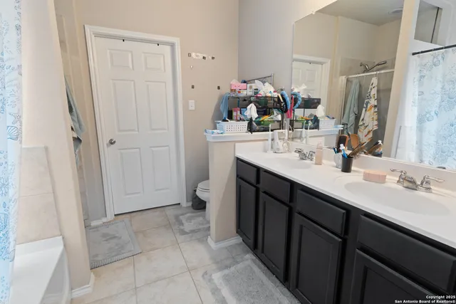 a bathroom with a sink vanity and mirror
