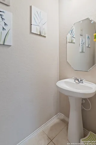 a bathroom with a sink and mirror