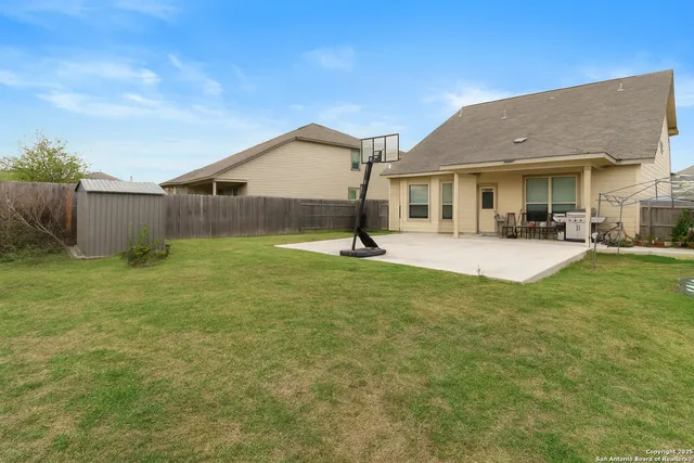a view of a house with a backyard and sitting area