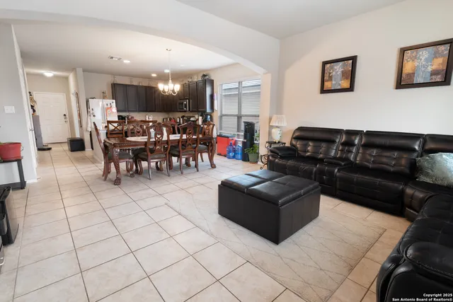 a living room with furniture and a kitchen view