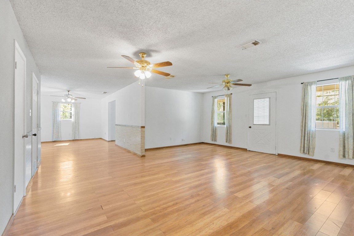 200 Little Pine Valley Road Cleveland, TX 77328 - Photo 14 of 43 a view of empty room with wooden floor and fan