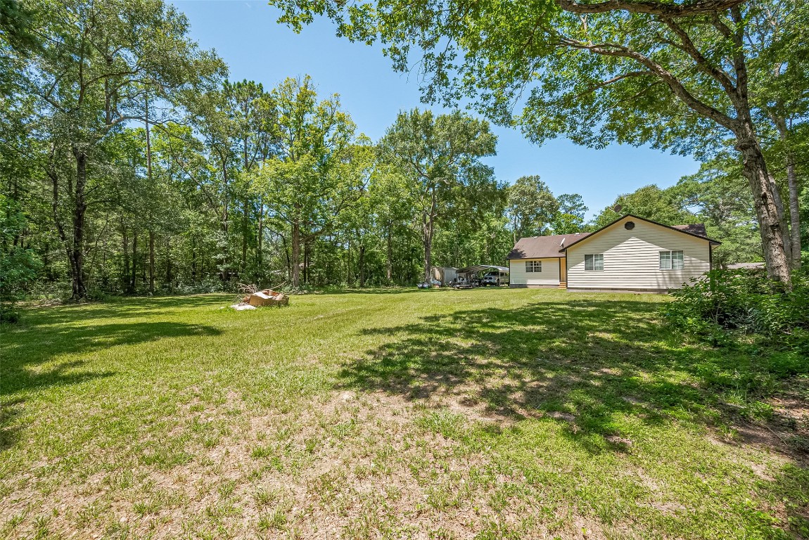 200 Little Pine Valley Road Cleveland, TX 77328 - Photo 35 of 43 a view of a house with a yard