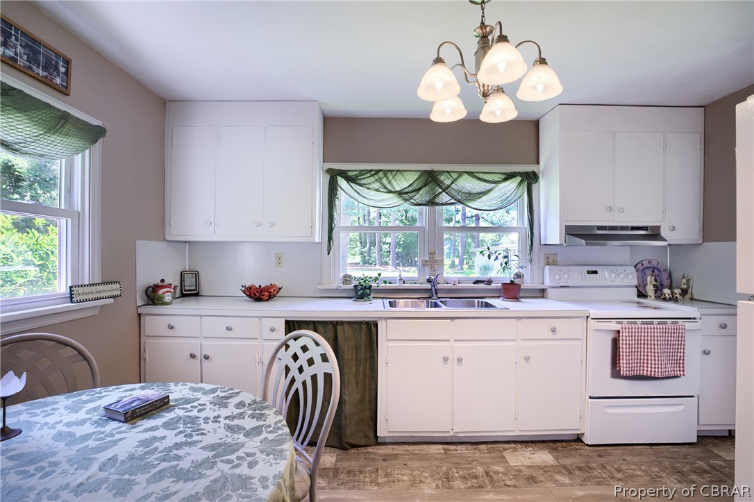 2442 Old Ferry Road Hudgins, VA 23076 - Photo 8 of 33 Kitchen with white cabinets, hanging light fixtures, sink, and white electric stove