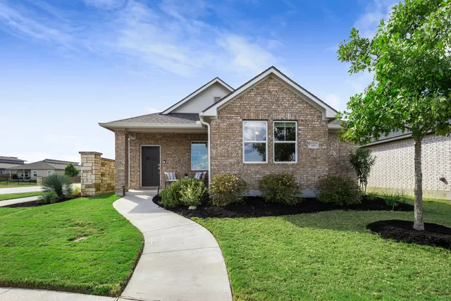 a front view of a house with garden