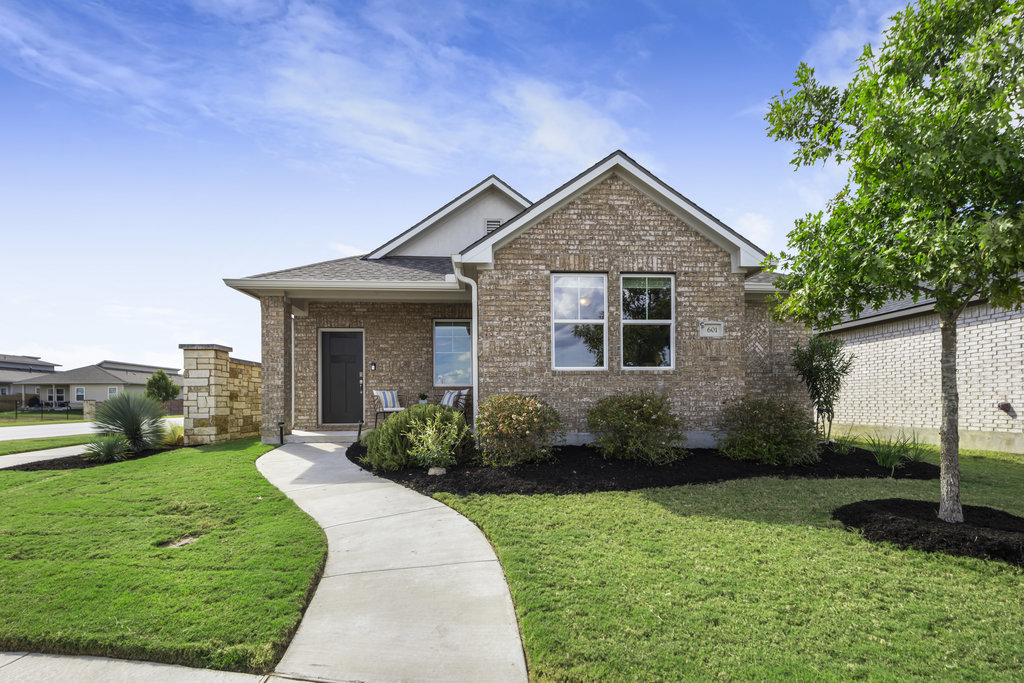 a front view of a house with garden