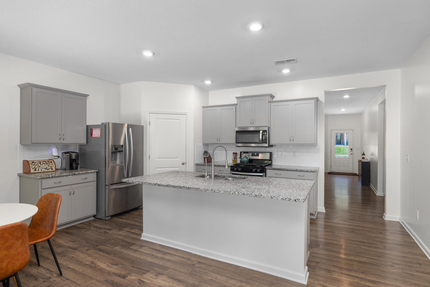 5132 Shellback Drive Millington, TN 38053 - Photo 6 of 24 a kitchen with granite countertop a refrigerator and a stove top oven
