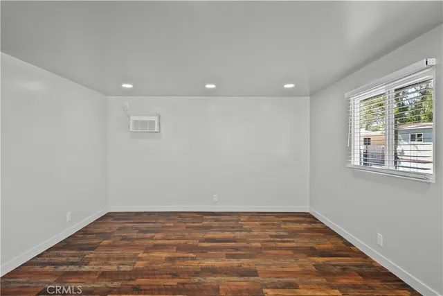 a large kitchen with stainless steel appliances granite countertop a sink a stove and a refrigerator