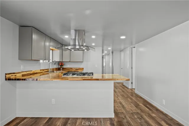 a kitchen with kitchen island a stove a sink and a refrigerator