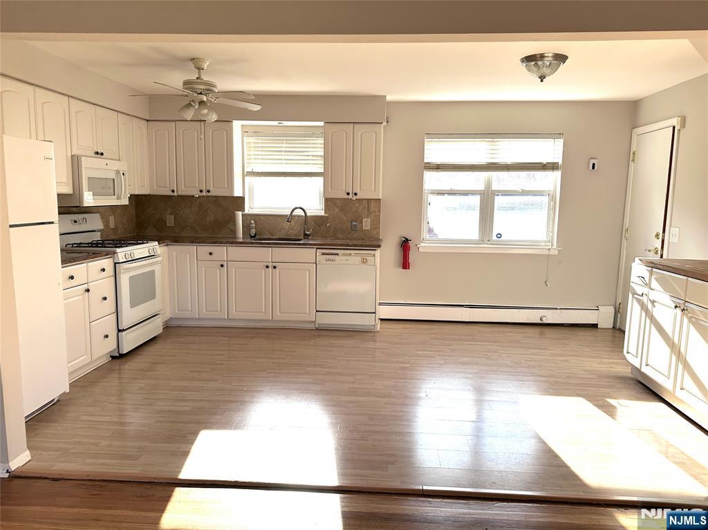 1165 A Valley Road, Unit 1165A Wayne, NJ 07470 - Photo 4 of 22 a kitchen with a sink cabinets stainless steel appliances and a window