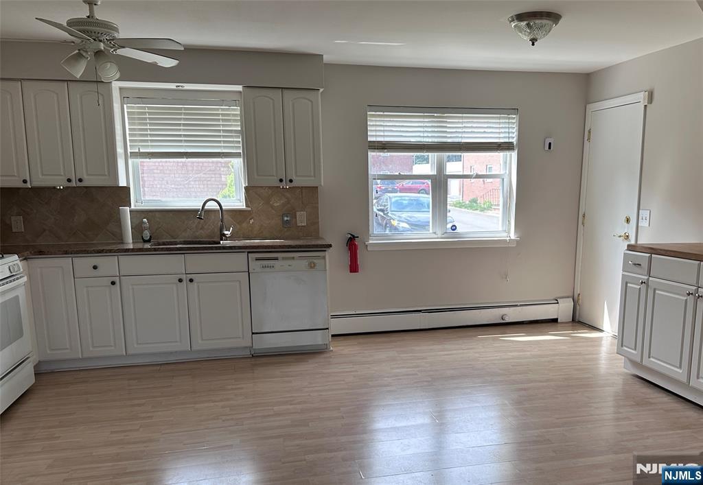 1165 A Valley Road, Unit 1165A Wayne, NJ 07470 - Photo 5 of 22 a kitchen with granite countertop a sink window and cabinets