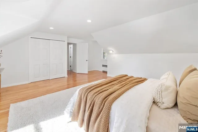 a bedroom with a bed and a night stand