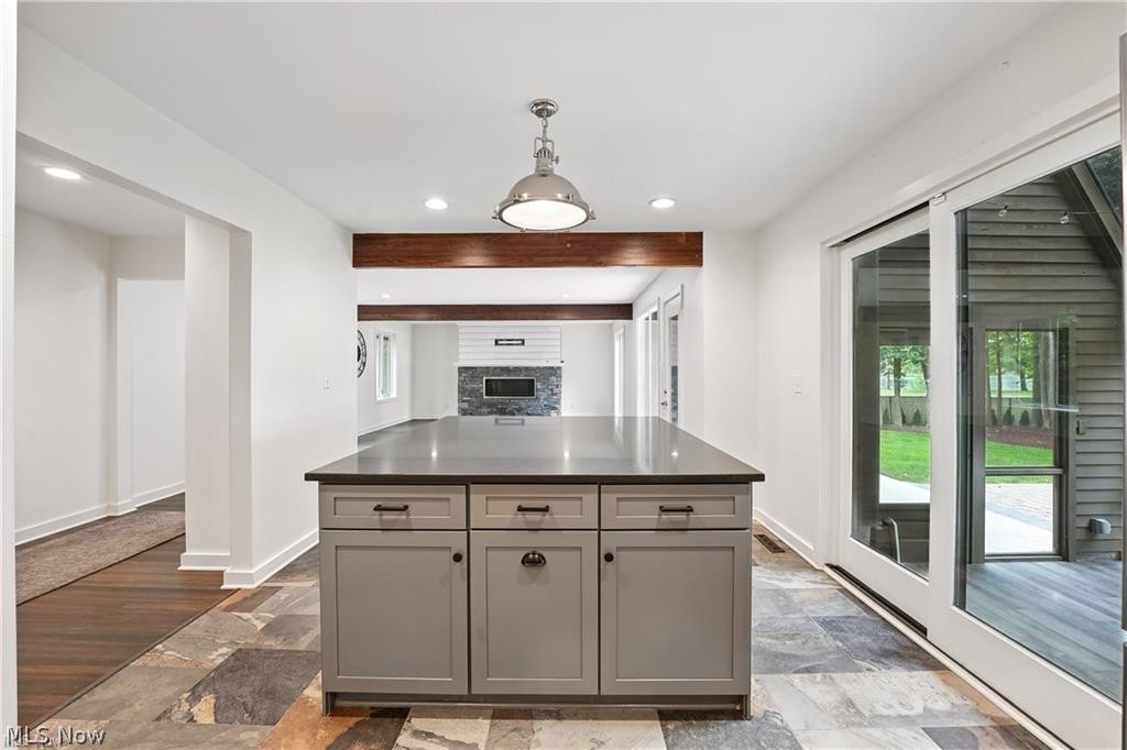 263 East Pine Lake Road North Lima, OH 44452 - Photo 17 of 50 Kitchen with gray cabinetry, hanging light fixtures, a kitchen island, dark stone finish flooring, and beam ceiling