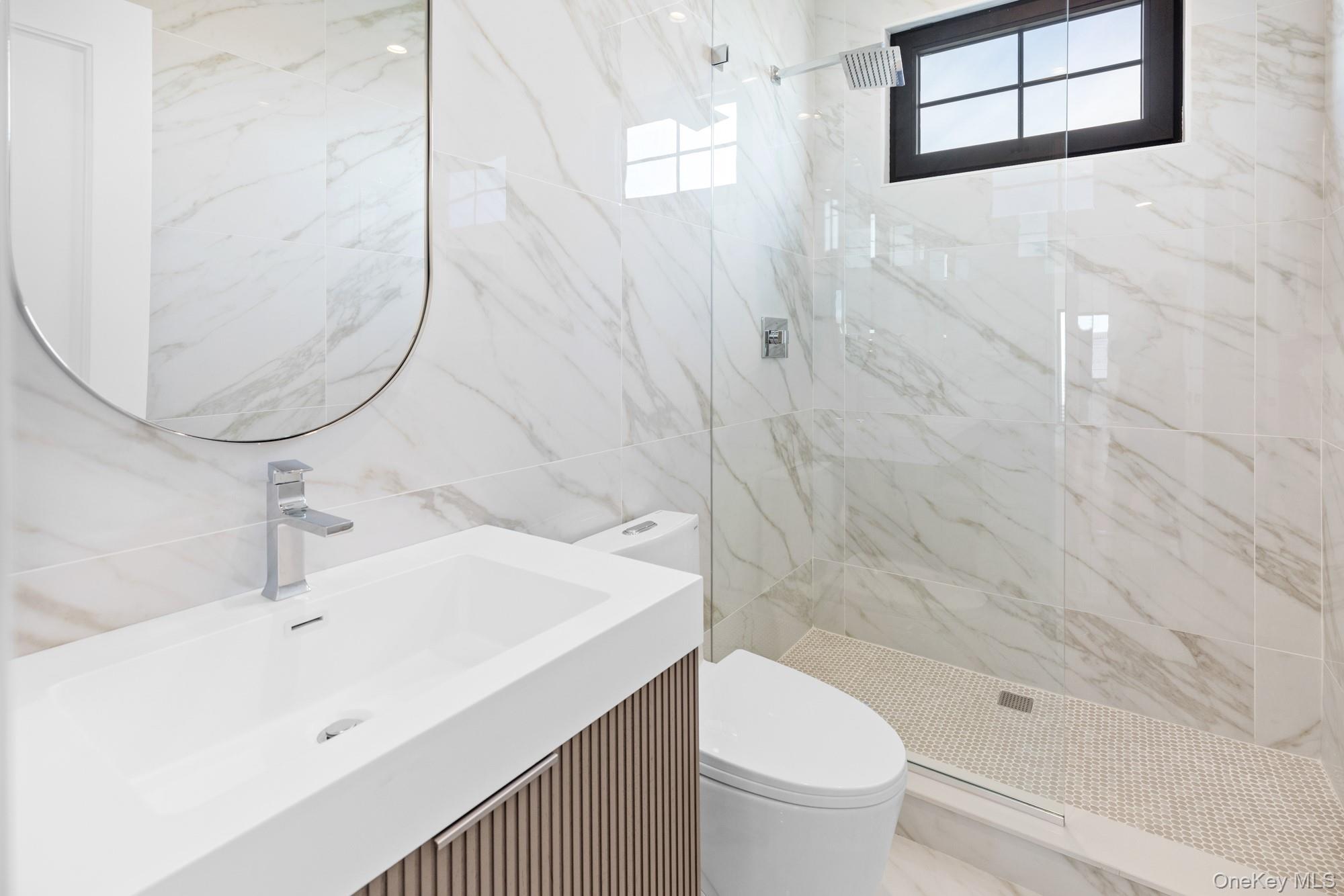 24 Midway Street Babylon, NY 11702 - Photo 26 of 40 Full bathroom with tile walls, vanity, and a marble finish shower