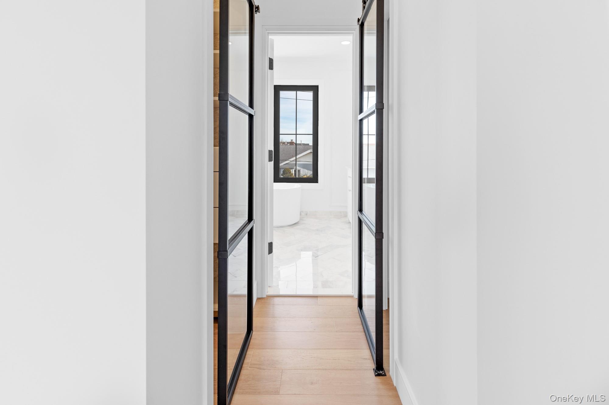 24 Midway Street Babylon, NY 11702 - Photo 31 of 40 Corridor featuring light wood-type flooring