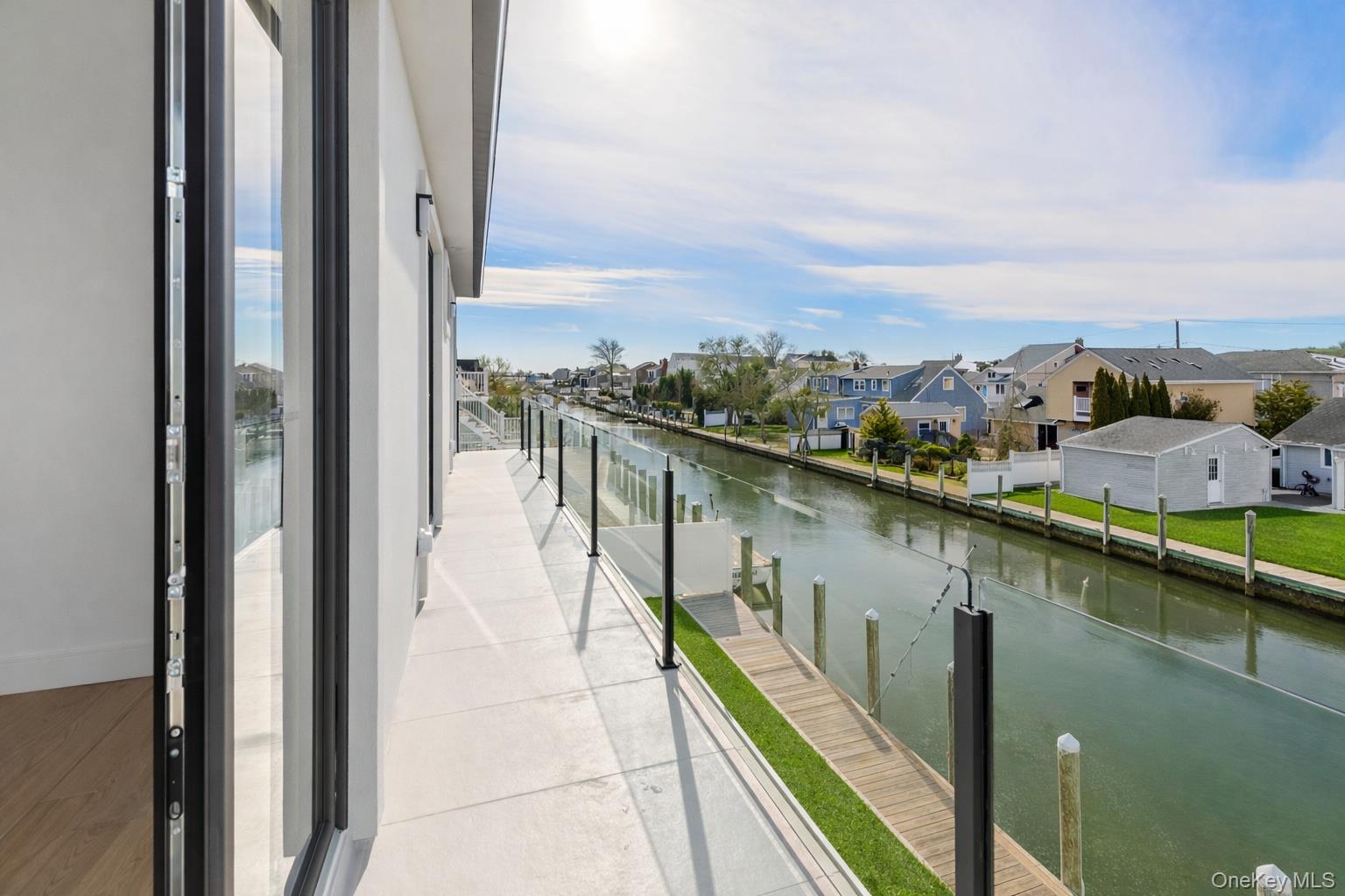 24 Midway Street Babylon, NY 11702 - Photo 37 of 40 Balcony featuring a water view, a residential view, and a boat dock