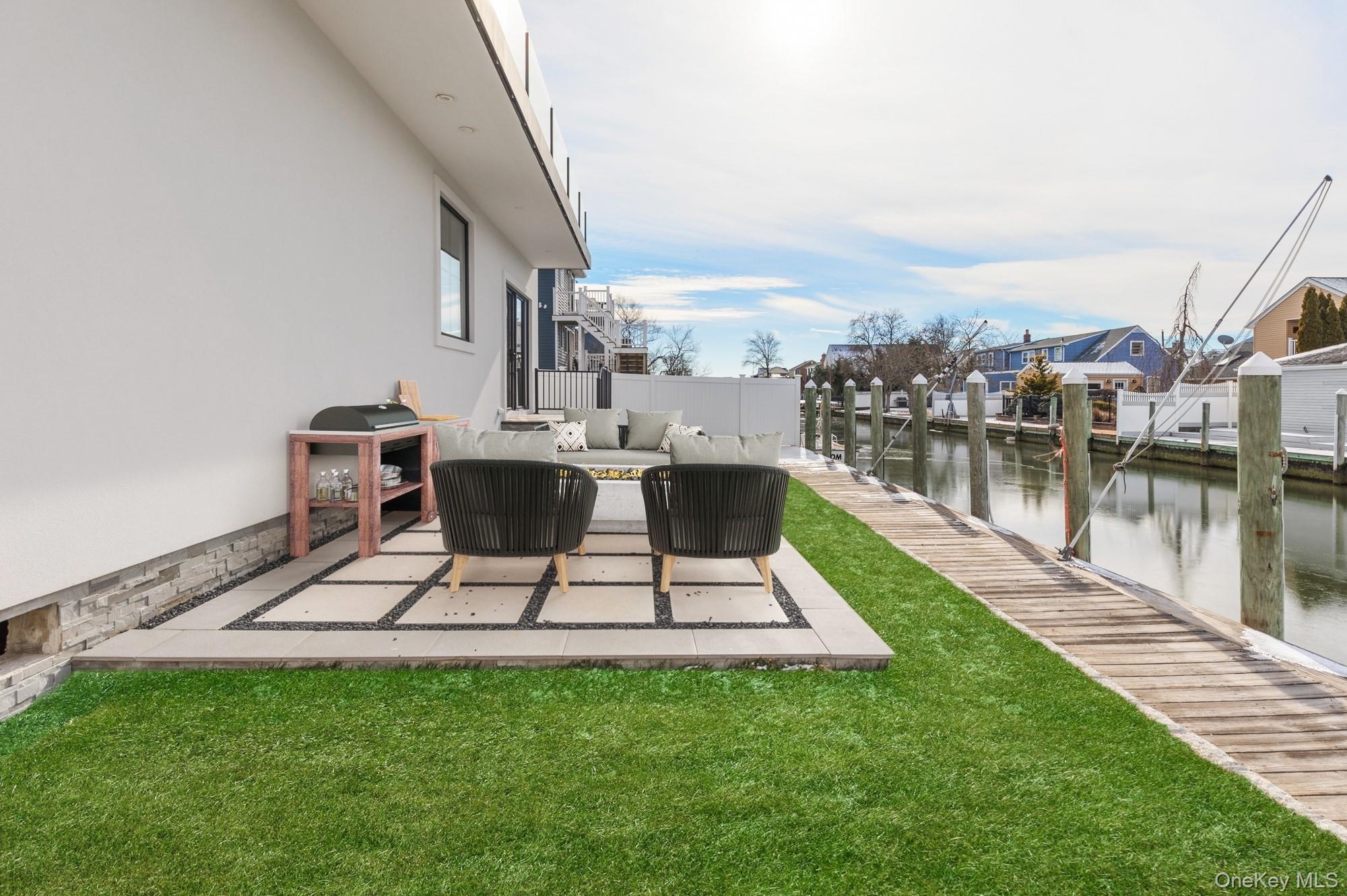 24 Midway Street Babylon, NY 11702 - Photo 39 of 40 View of patio with an outdoor living space and a water view