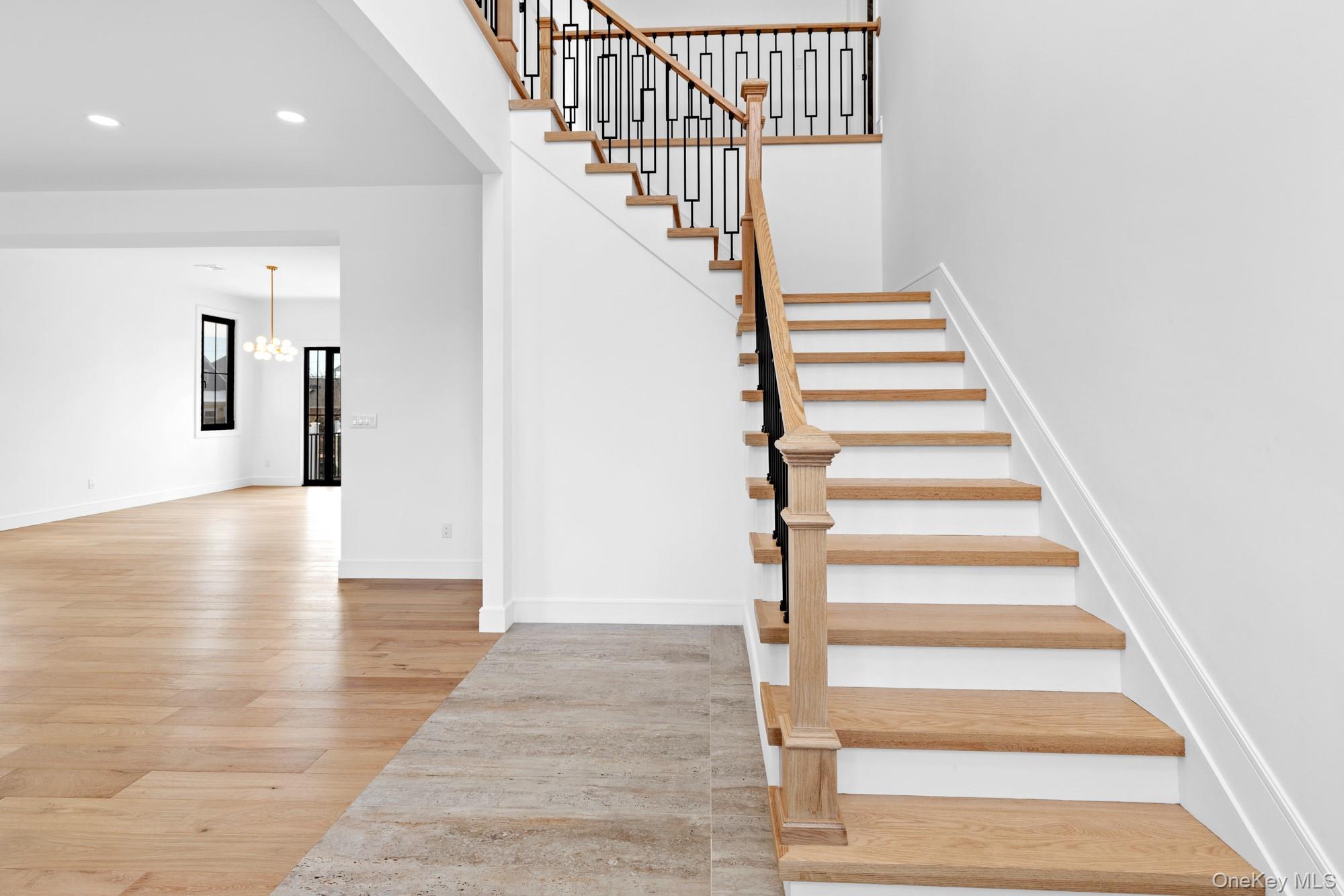 24 Midway Street Babylon, NY 11702 - Photo 4 of 40 Stairs featuring wood-type flooring, a chandelier, and recessed lighting