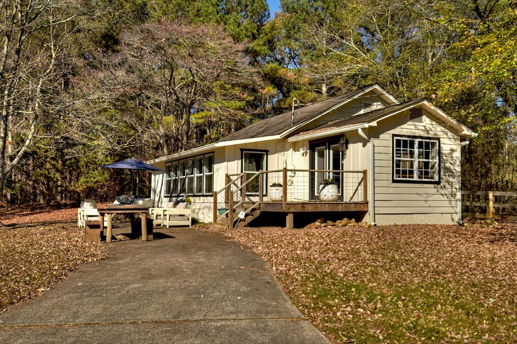a front view of a house with sitting area