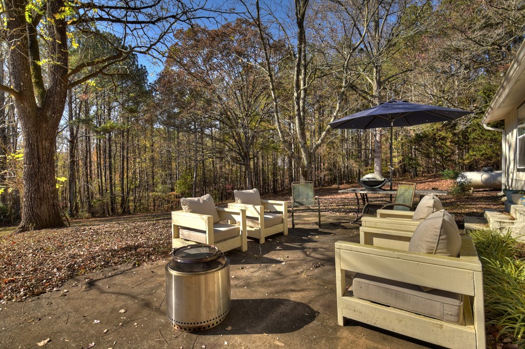 3380 Clear Creek Road Ellijay, GA 30536 - Photo 12 of 39 a view of a patio with table and chairs under an umbrella