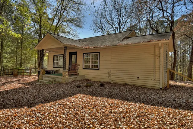 a view of a yard with trees in front of it