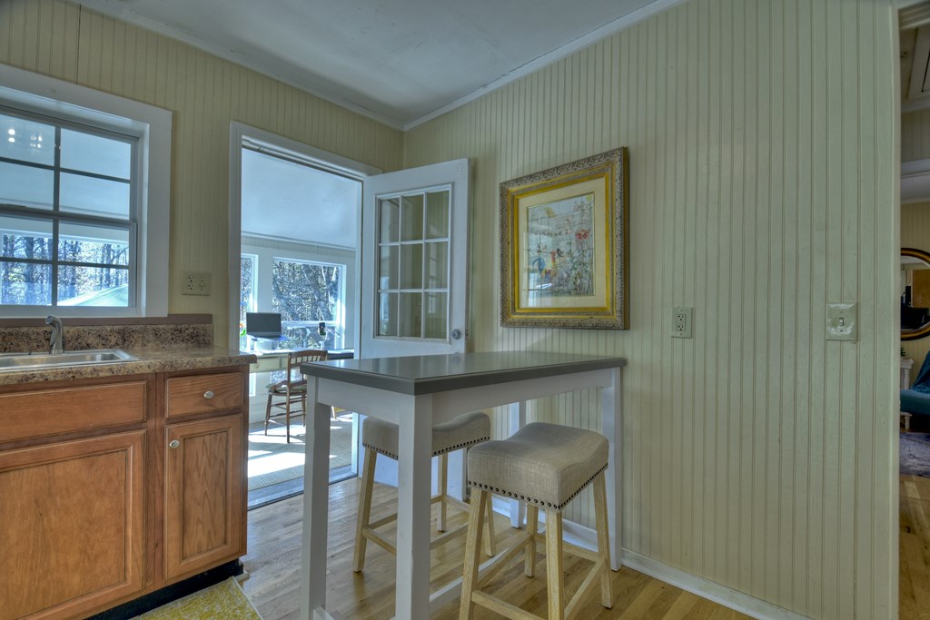 3380 Clear Creek Road Ellijay, GA 30536 - Photo 23 of 39 a kitchen with granite countertop wooden cabinets and dining table
