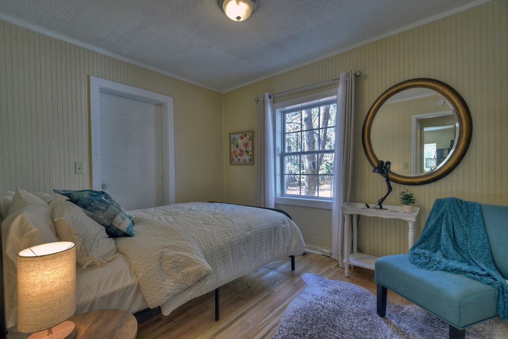 3380 Clear Creek Road Ellijay, GA 30536 - Photo 28 of 39 a bedroom with a bed chair and a large window