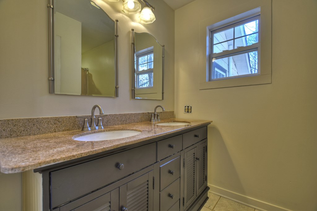 3380 Clear Creek Road Ellijay, GA 30536 - Photo 33 of 39 a bathroom with a granite countertop sink and a mirror