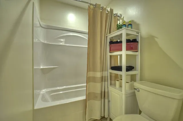 a bedroom with a bed and a mirror