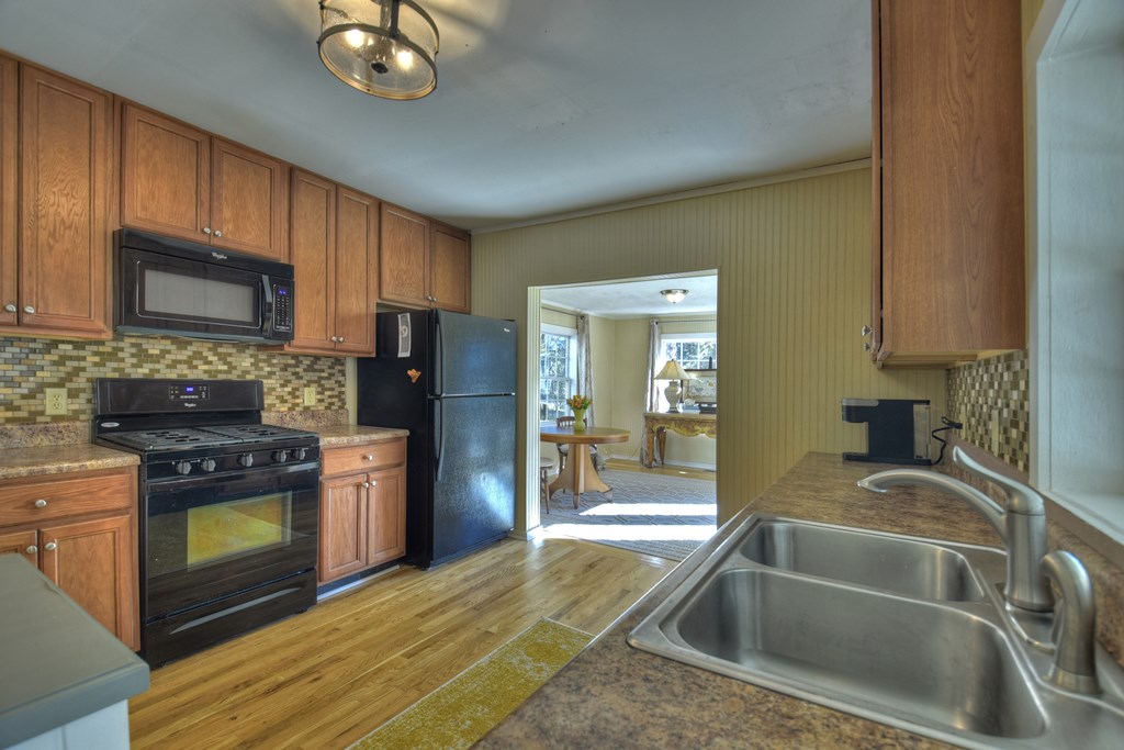 3380 Clear Creek Road Ellijay, GA 30536 - Photo 36 of 39 a kitchen with granite countertop a sink stainless steel appliances a counter space and cabinets
